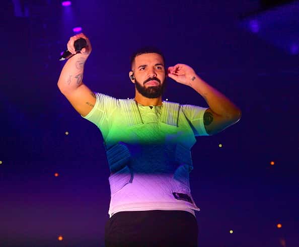 Drake perfroming in green blue and purple shirt