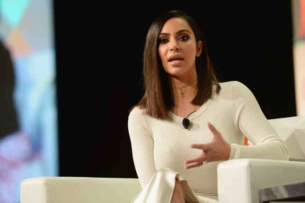 Kim Kardashian in white on white chair at talk show