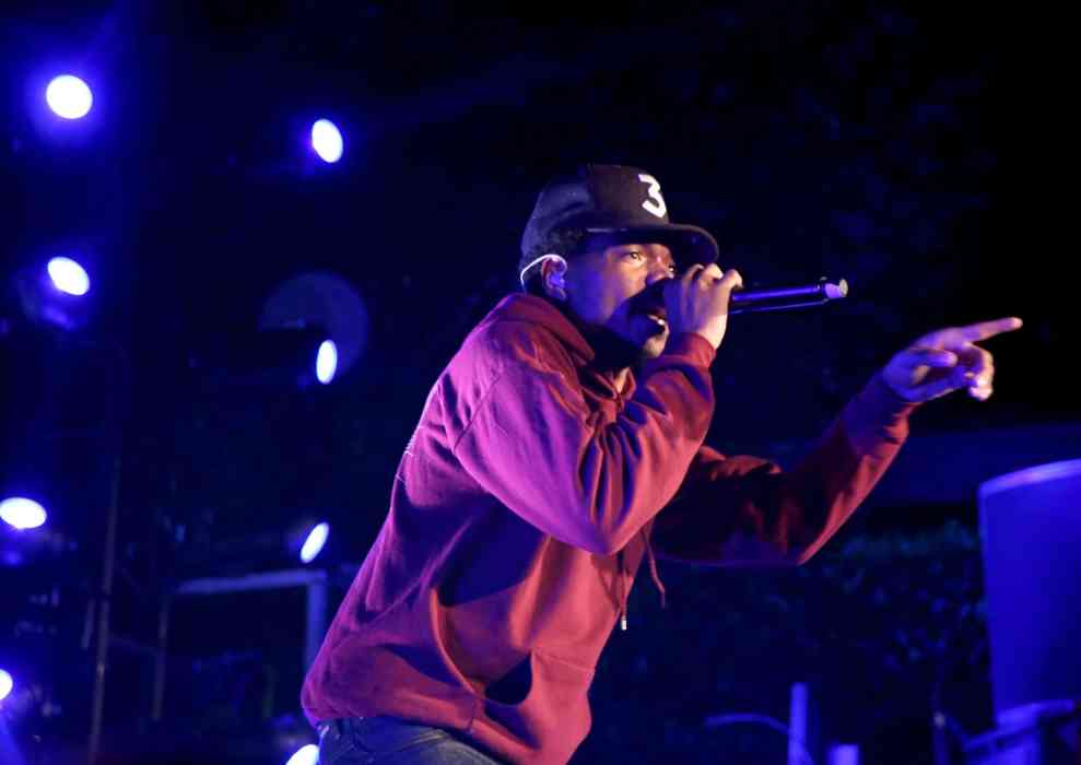 Chance the Rapper performing in black baseball cap reading 3