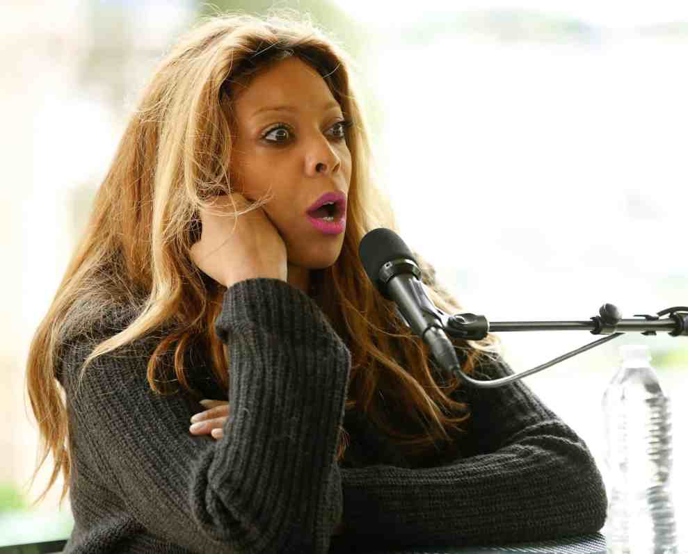 Wendy Williams with shocked face in front of microphone