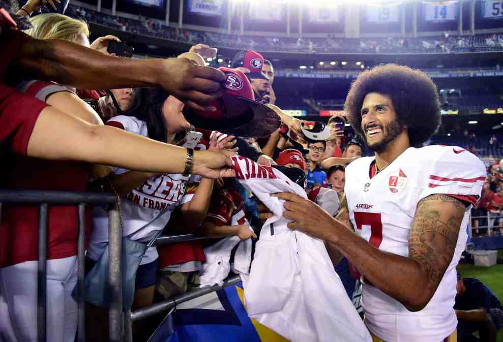 Colin Kapernick in #7 49ers jersey singing autographs after a game