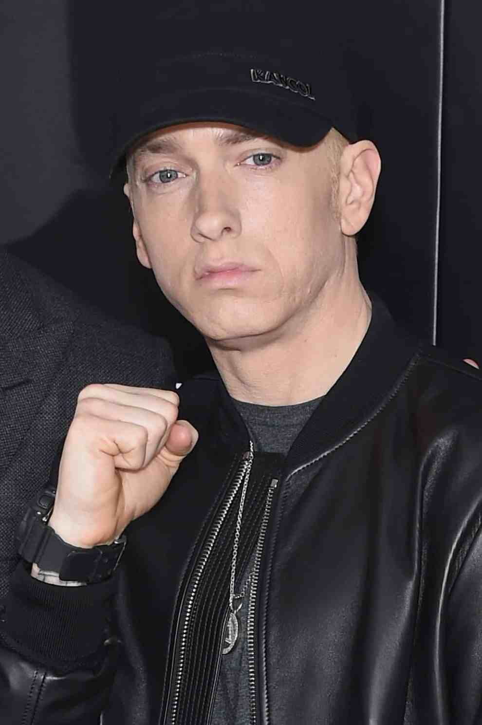 Eminem in all black with right hand in fist