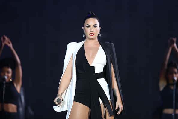 Demi Lovato performs in black and white outfit