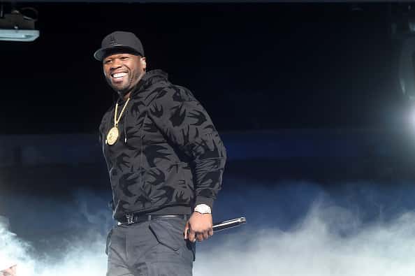50 Cent performing on stage with smoke
