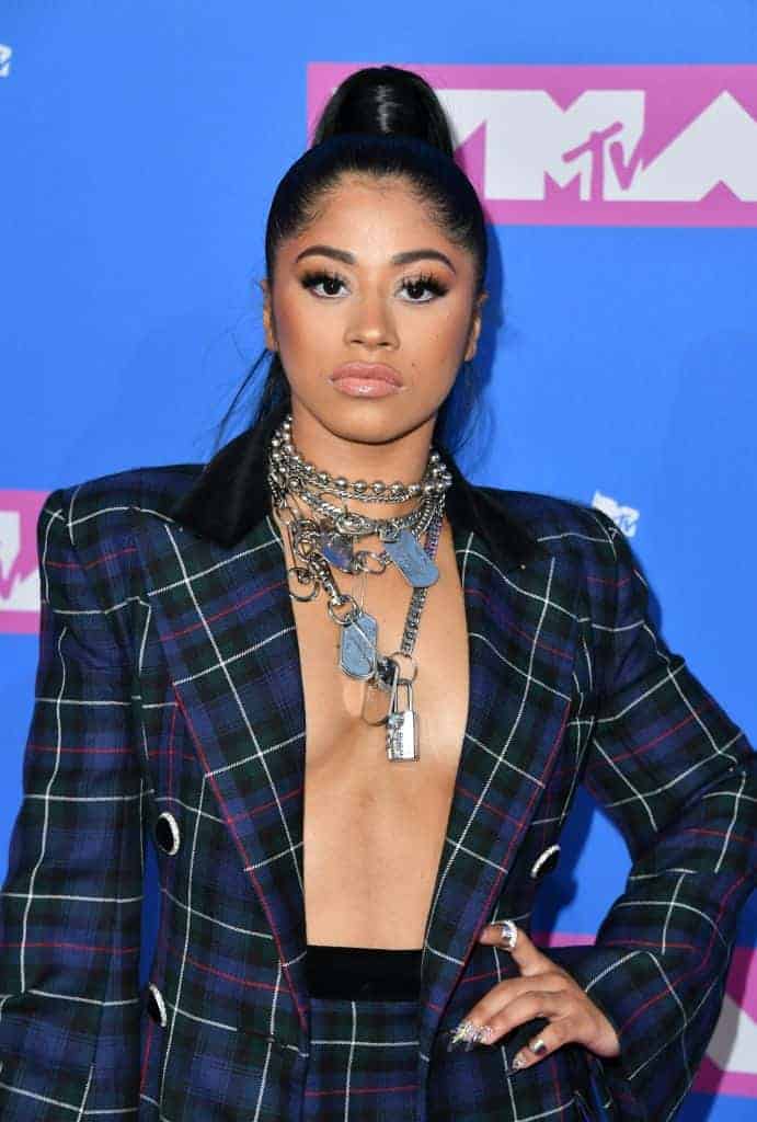 Hennessy Carolina wearing a plaid suit standing in front of a blue background at the MTV VMAs