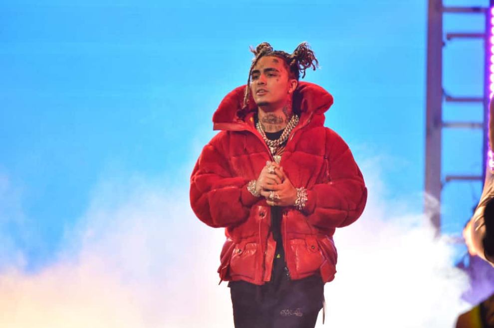 Lil Pump wearing a red jacket on stage