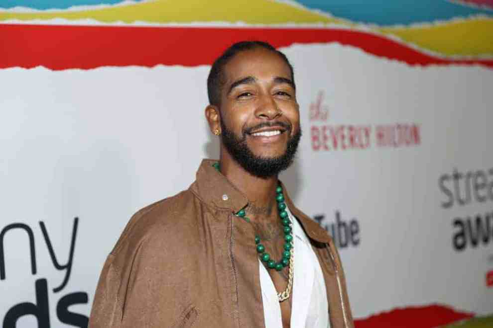 Omarion wearing tan and white