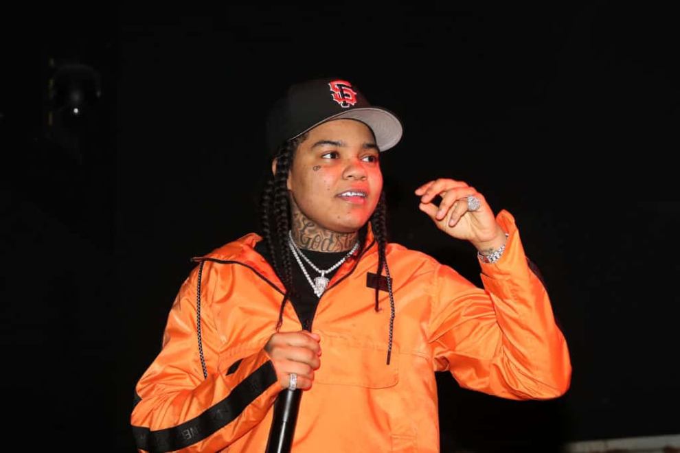 Young M.A wearing orange