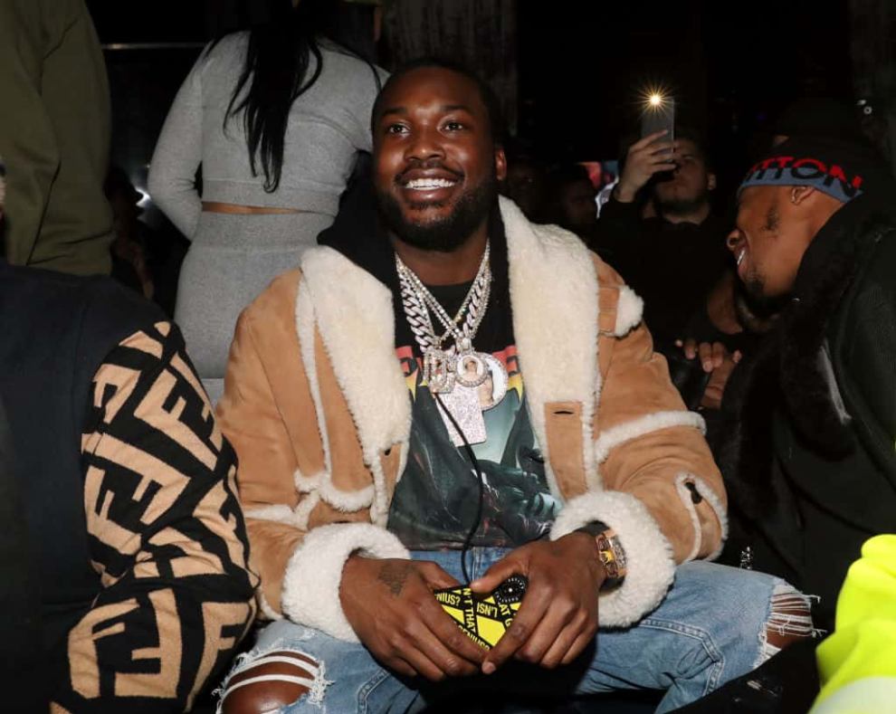 Meek Mill smiling while sitting in crowd