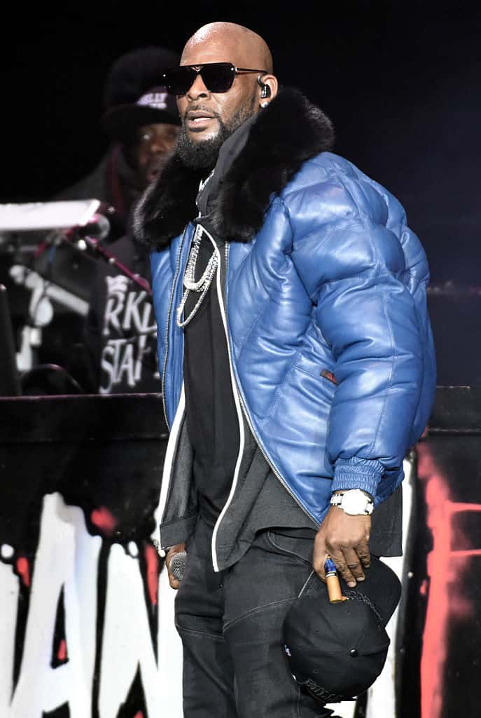 R. Kelly wearing a blue jacket on stage