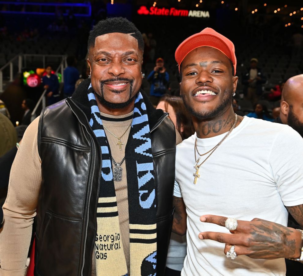 Comedians/actors Chris Tucker and D.C. Young Fly attend the game between Memphis Grizzlies and the Atlanta Hawks at State Farm Arena on December 23, 2023 in Atlanta, Georgia. NOTE TO USER: User expressly acknowledges and agrees that, by downloading and or using this photograph, User is consenting to the terms and conditions of the Getty Images License Agreement.