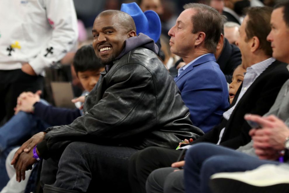 Kanye West, left, and his son, Saint West, got front row seats next to Golden State Warriors co-owners Joe Lacob and Peter Guber as they watch the game against the Boston Celtics in the second quarter at Chase Center in San Francisco, Calif., on Wednesday, March 16, 2022.